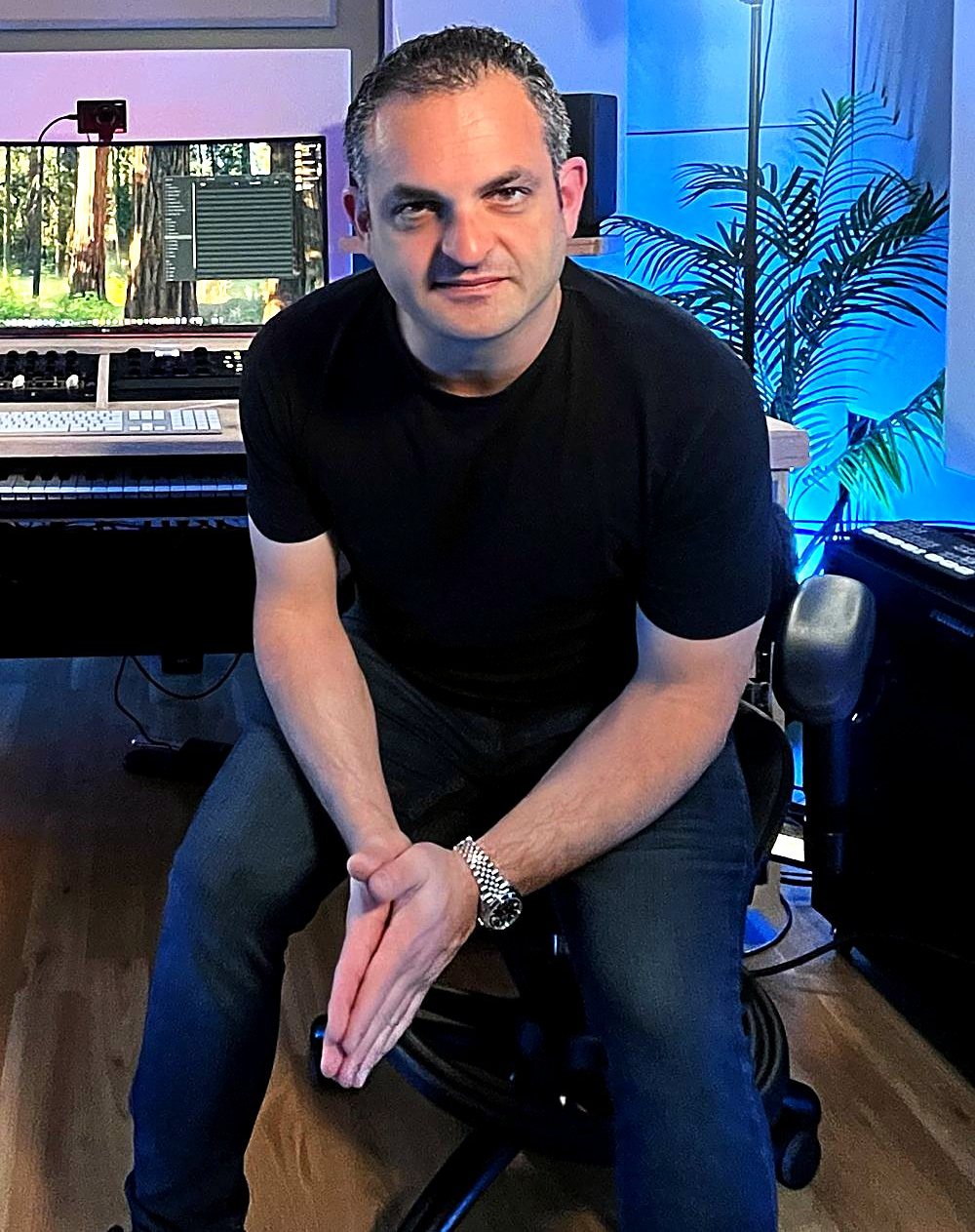 Freddie Harb seated at his mastering desk